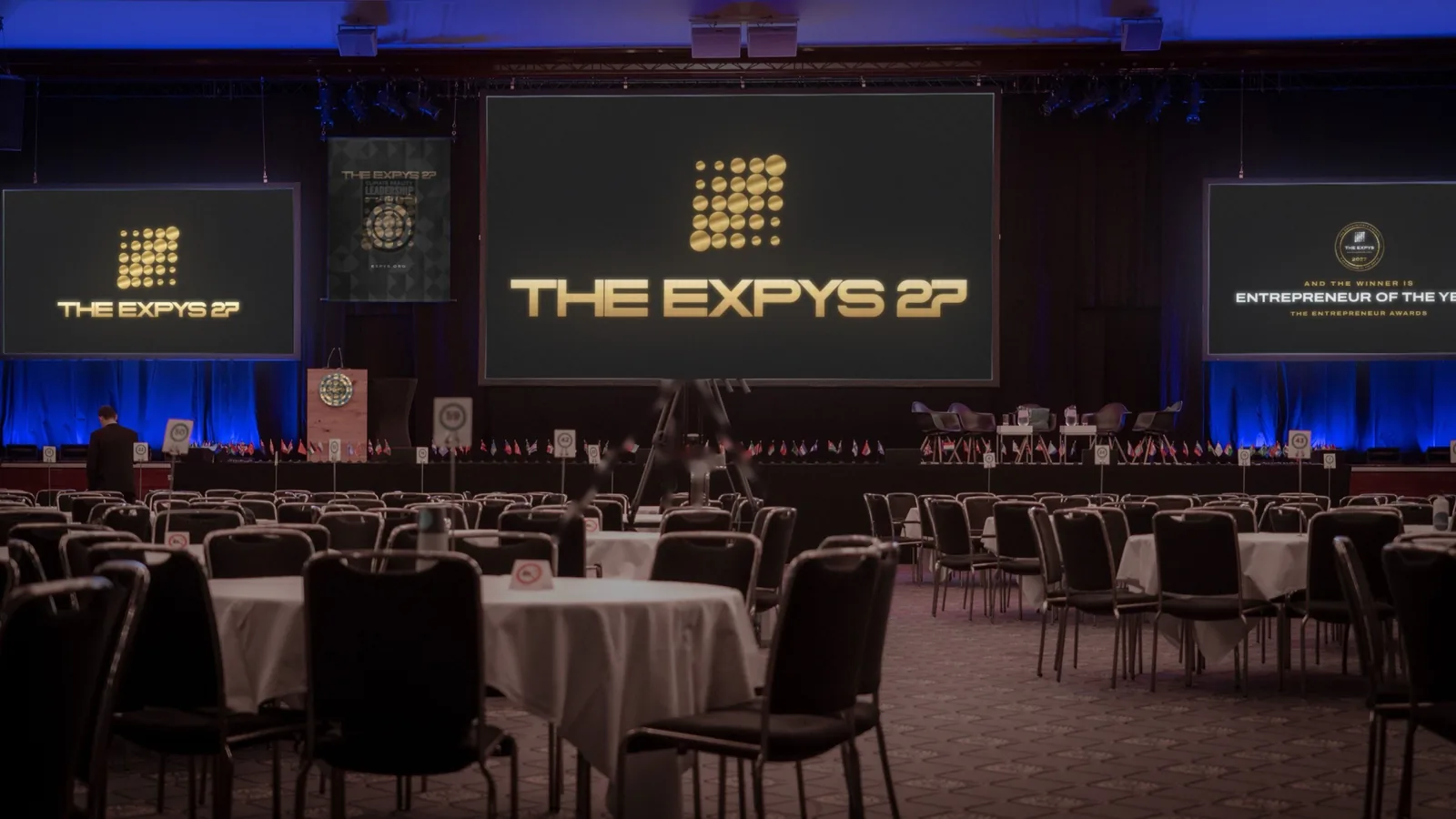 A ballroom set for dinner, THE EXPYS 27 on the big screen