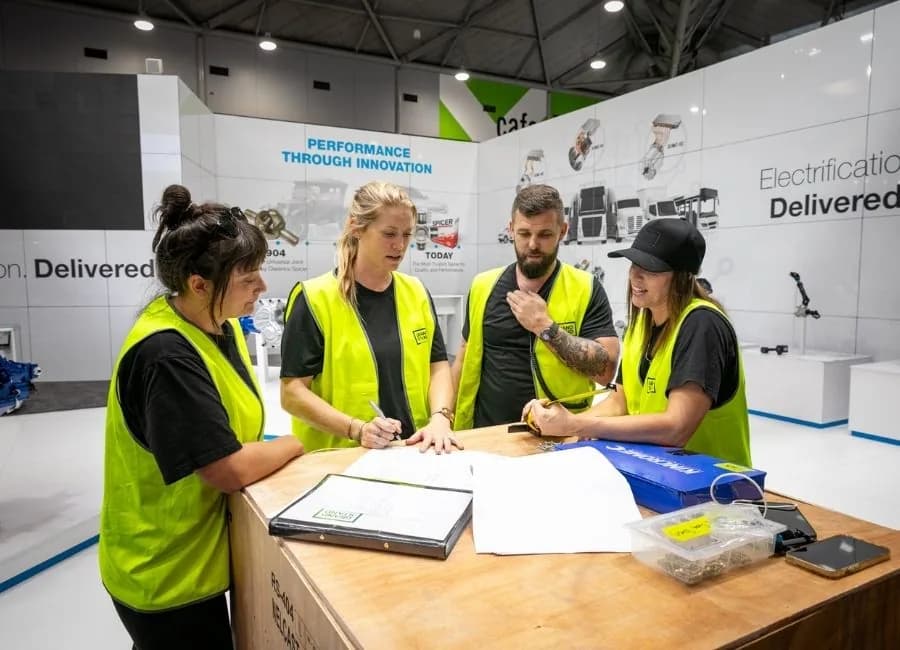 The crew around the floor plan on the morning of the build