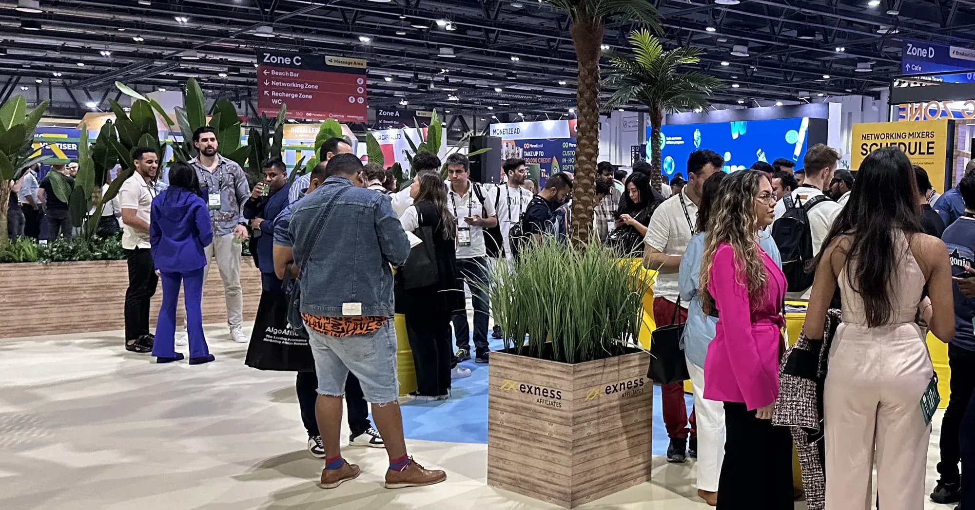 Visitors on a busy show floor between the stands