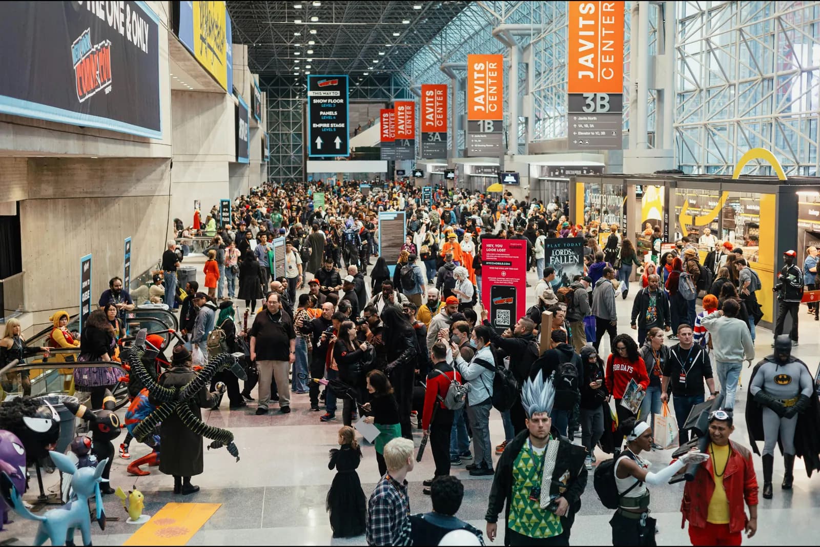 Cosplayers in a packed convention centre concourse