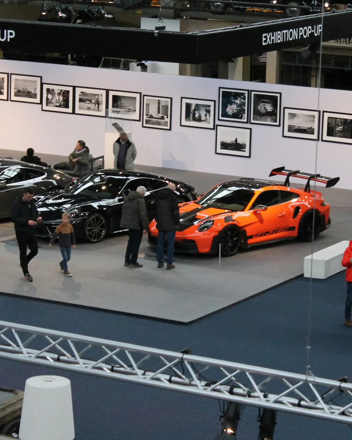 Sports cars on an exhibition hall floor