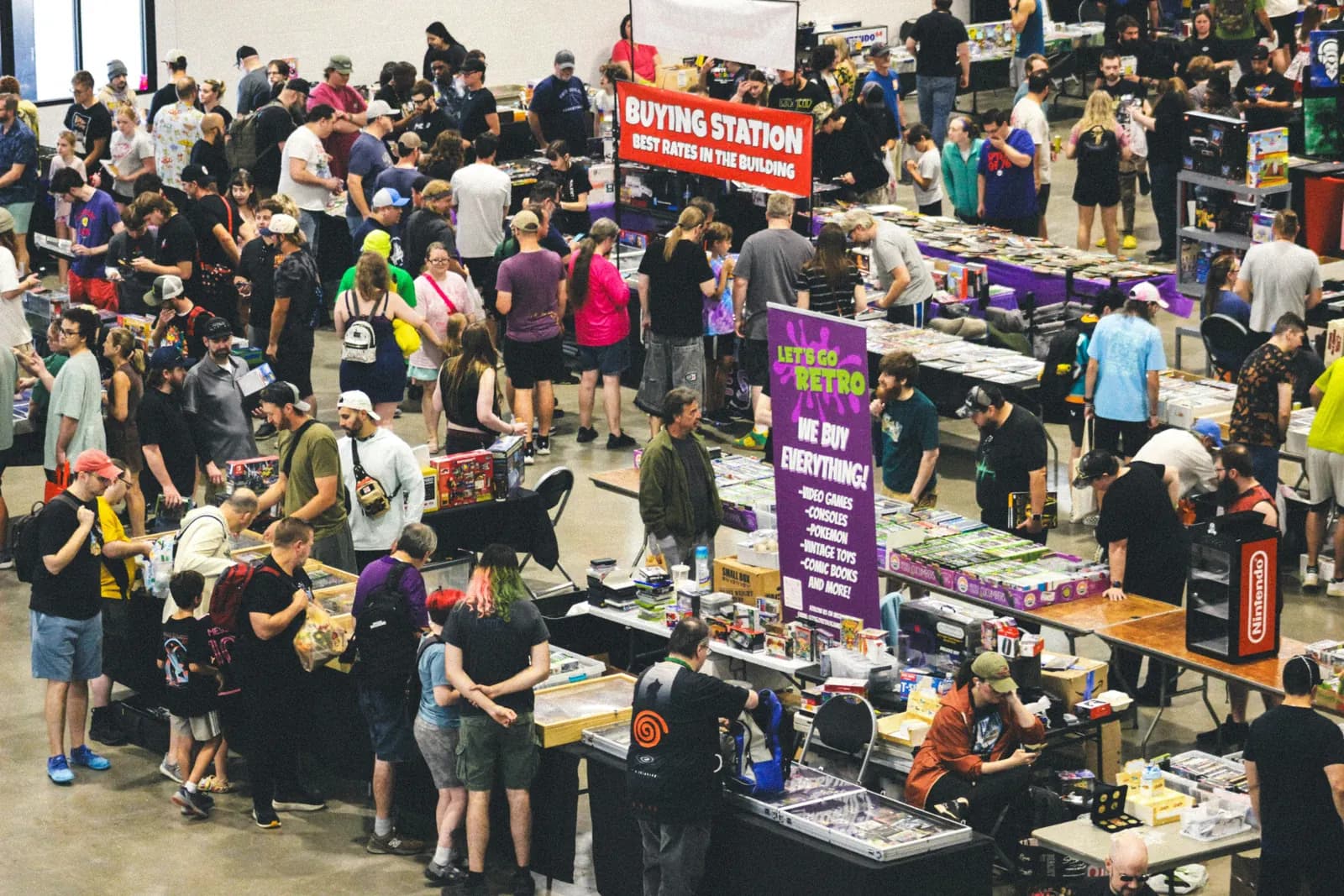 A crowd around a retro games buying station