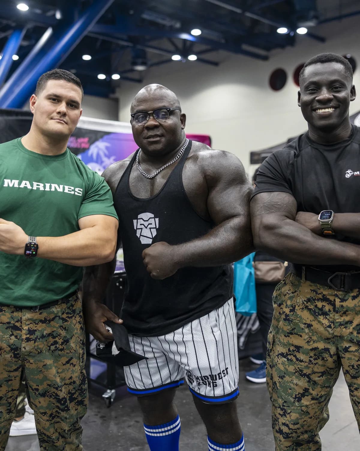 Bodybuilders posing at a fitness expo stand