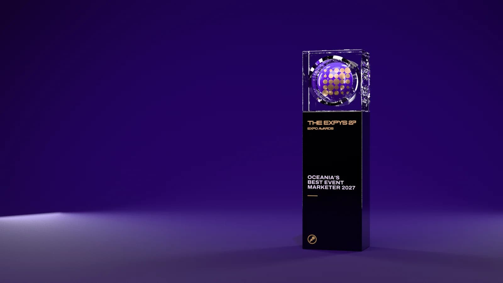 The Expo Awards trophy, black with a dot grid sphere, on a dark stage